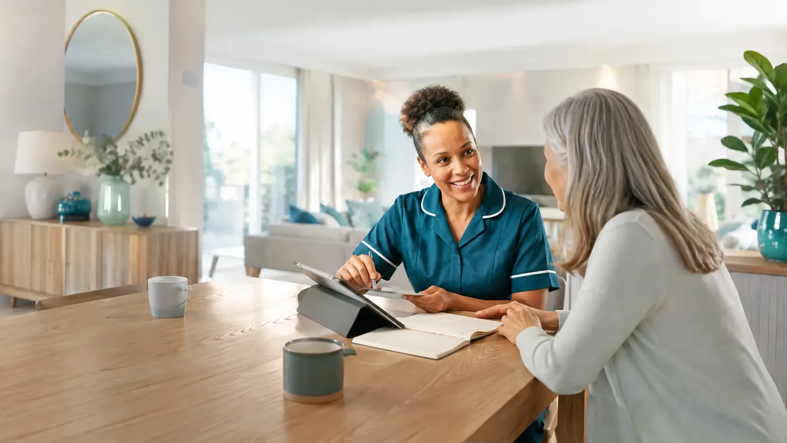 A carer discussing a care plan with a client and family member over coffee